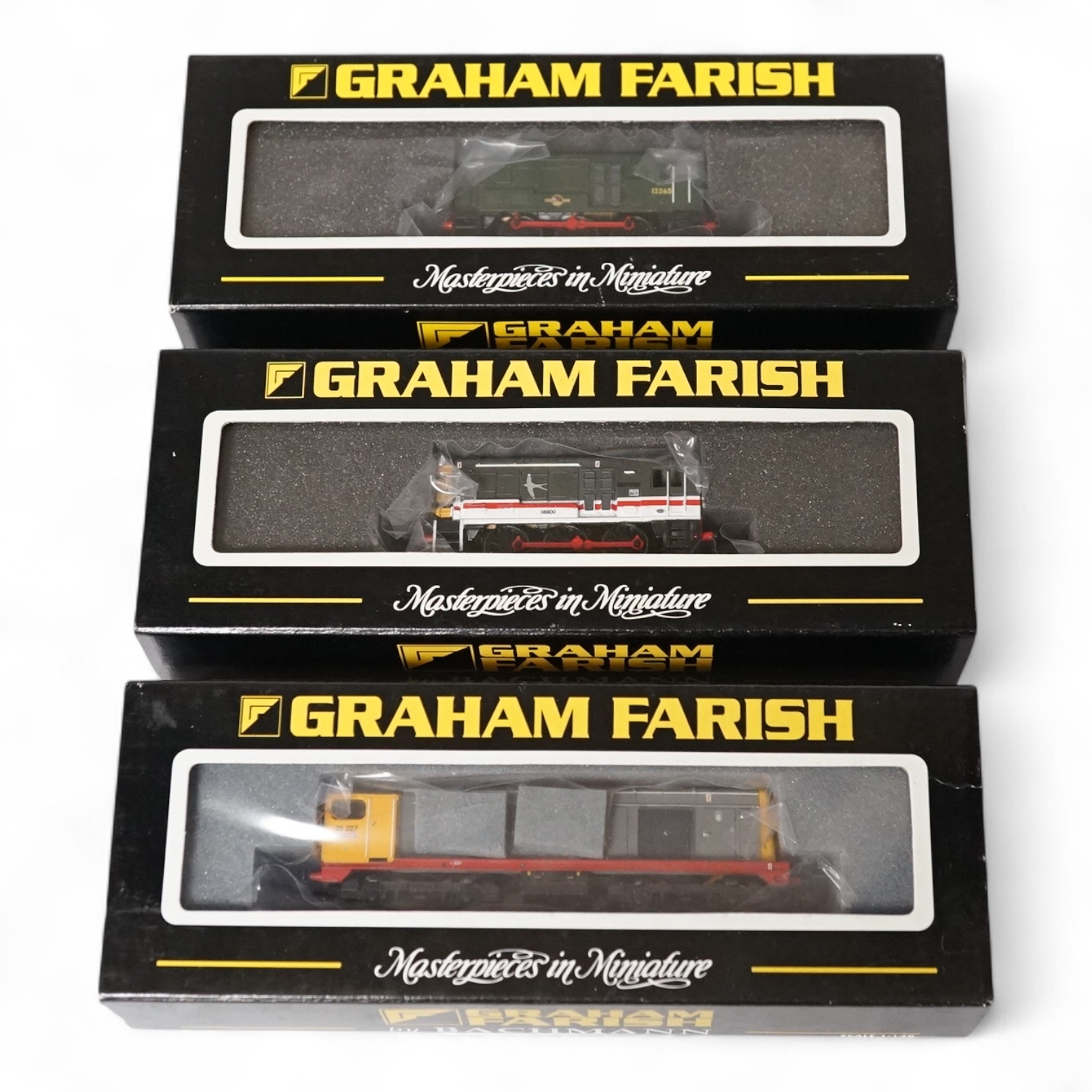 Three boxed Graham Farish N gauge railway diesel locomotives; Class 08, 08800 (371005), Class 08, 13365 (371003) and Class 20, 20227 (371-027). Condition - good.